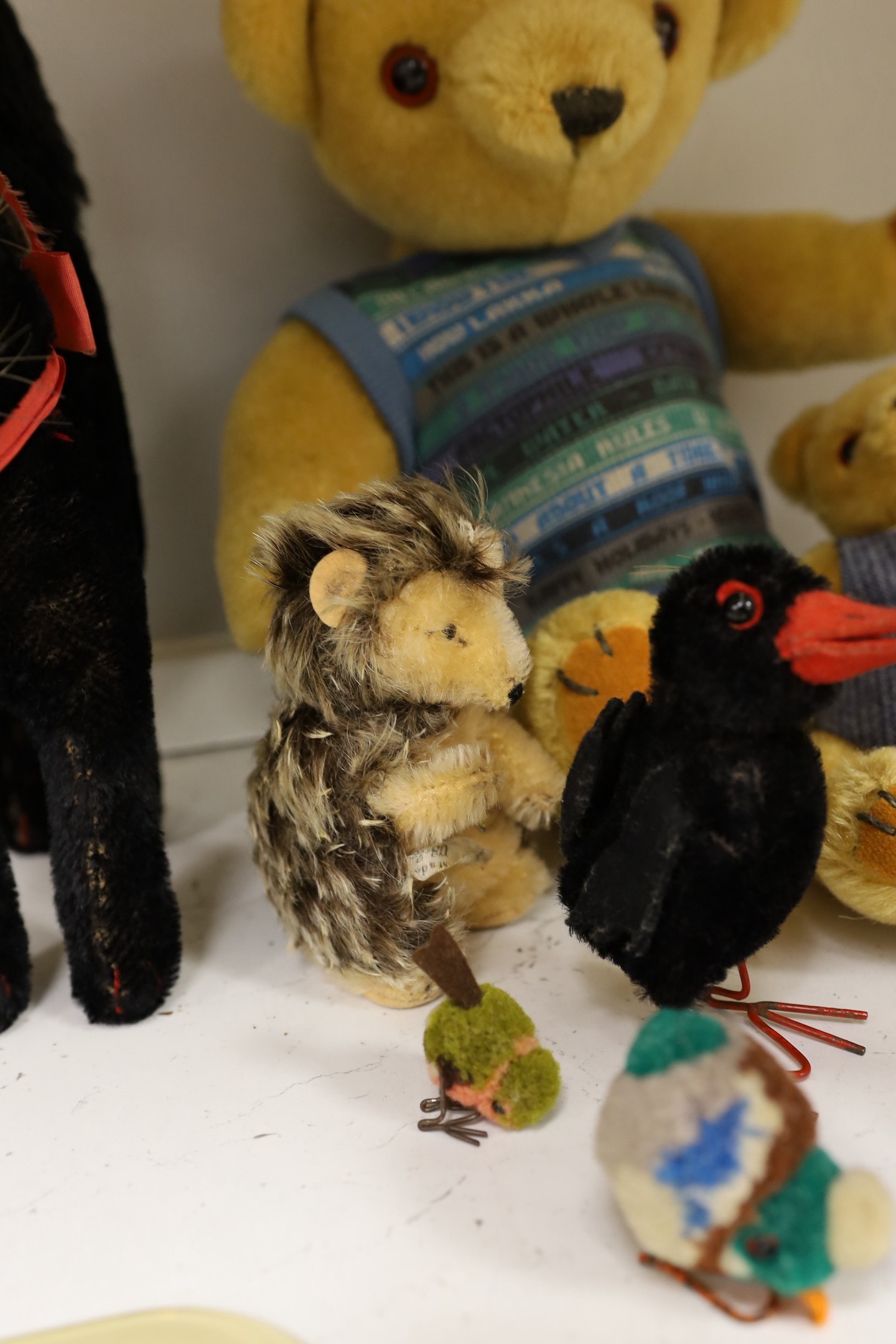 A collection of toys - a small black cat, a large black cat, a small pig, a hedgehog, a Macki hedgehog, two crows, a duck, two small birds with wire feet and two Peter Bull bears with pedigree certs. (12)